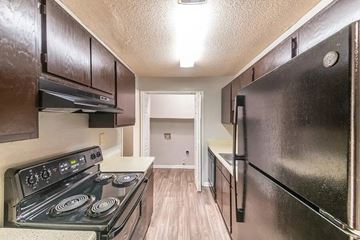 Gainesville apartment for rent - A kitchen with a stove top oven and a refrigerator.