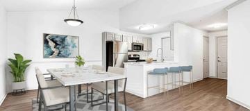 Newnan apartment for rent - A modern kitchen with a dining table and chairs.