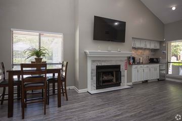 Greensboro apartment for rent - A living room with a fireplace and a television mounted on the wall.