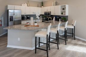 Frisco apartment for rent - a kitchen with white cabinets and a granite counter top