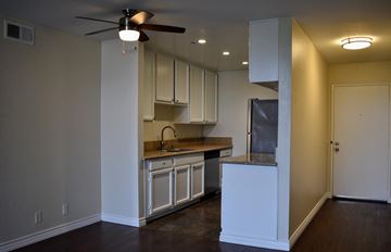 Glendale apartment for rent - A kitchen with white cabinets and a fan on the ceiling.