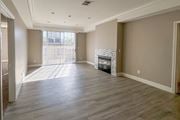 Sherman Oaks apartment for rent - A spacious living room with a fireplace and hardwood floors.