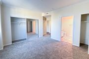 Sherman Oaks apartment for rent - A sparsely furnished apartment with a carpeted floor and white walls.