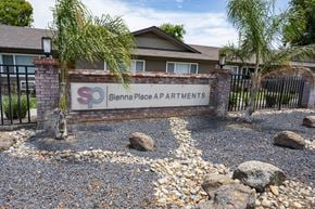 Manteca apartment for rent - The image shows a sign for Sienna Place Apartments in front of a gated entrance.