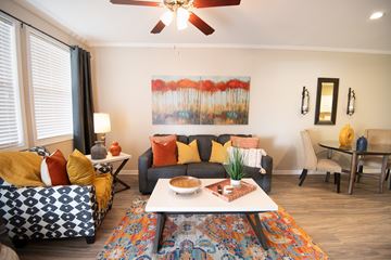 Temecula apartment for rent - A living room with a couch, a chair, a coffee table, and a painting on the wall.