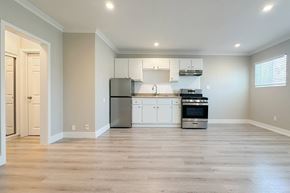 Hollywood apartment for rent - A kitchen with white cabinets and stainless steel appliances.