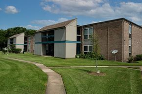 Stafford apartment for rent - A building with a green lawn in front of it.