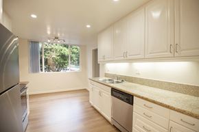Marina Del Rey apartment for rent - A kitchen with white cabinets and a granite countertop.