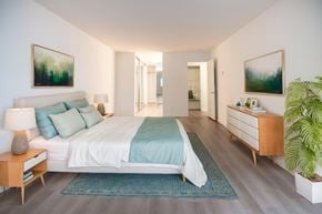 Marina Del Rey apartment for rent - A bedroom with a bed, nightstand, and a plant.