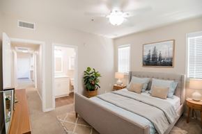 Murrieta apartment for rent - A bedroom with a large bed and a ceiling fan.