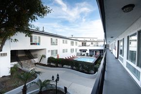 La Crescenta apartment for rent - A white building with a pool in the courtyard.