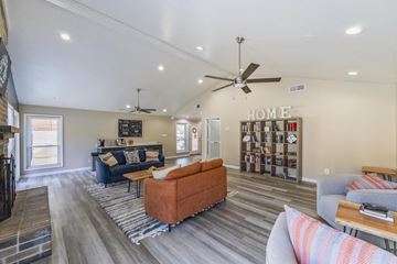 Huntsville apartment for rent - A living room with a blue couch and a bookshelf.
