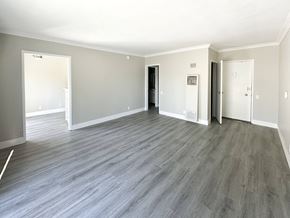 West Hollywood apartment for rent - A spacious room with grey flooring and white walls.