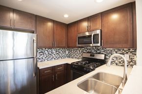 Los Angeles apartment for rent - A kitchen with a stainless steel refrigerator, microwave, and stove.