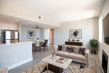 Los Angeles apartment for rent - A modern living room with a white couch and a coffee table.