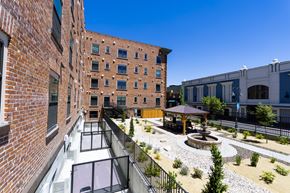 Reno apartment for rent - A courtyard with a fountain and a gazebo is surrounded by brick buildings.