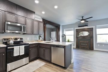 Reno apartment for rent - A modern kitchen with dark wood cabinets and stainless steel appliances.
