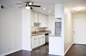Glendale apartment for rent - A kitchen with white cabinets and a ceiling fan.