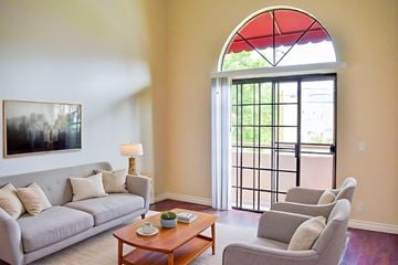 Glendale apartment for rent - A living room with a grey couch, a coffee table, and a painting on the wall.