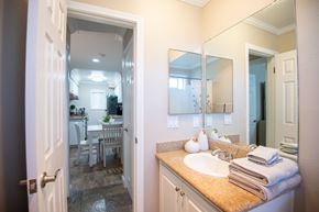 Torrance apartment for rent - A bathroom with a sink, mirror, and a view of the dining area.