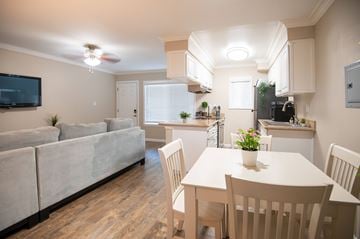 Torrance apartment for rent - A well-lit, spacious kitchen and living room with a dining table set for four.