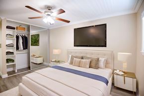 Torrance apartment for rent - A bedroom with a large bed and a flat screen TV mounted on the wall.