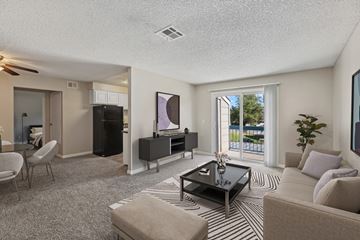 Reno apartment for rent - A living room with a black coffee table and striped rug.