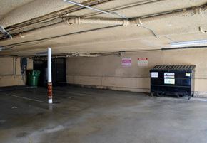 Los Angeles apartment for rent - the inside of a parking garage with bins and a pole