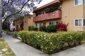 Los Angeles apartment for rent - the exterior of an apartment building with a sidewalk and landscaping
