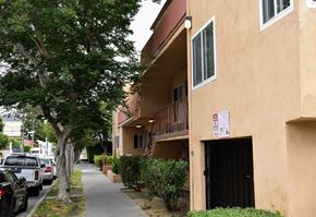 Los Angeles apartment for rent - an apartment building with a sidewalk and a tree in front of it