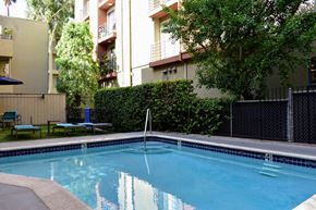 Hollywood apartment for rent - View of gated community pool with lounge chairs and seating