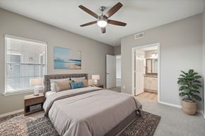 Frisco apartment for rent - A bedroom with a large bed and a ceiling fan.