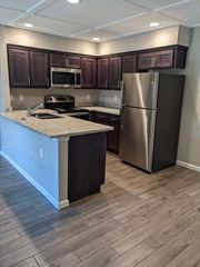 Citrus Heights apartment for rent - View of kitchen  with granite counters, stainless appliances, and brown cabinets