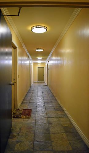 Los Angeles apartment for rent - a hallway with yellow walls and a tile floor and a door