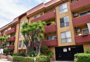 Los Angeles apartment for rent - an apartment building with palm trees in front of it