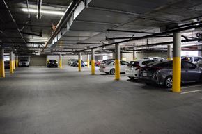 Reseda apartment for rent - a parking garage with cars in it and yellow pillars