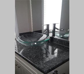 Redondo Beach apartment for rent - stone bathroom vanity top with glass vessel sink and large mirror.