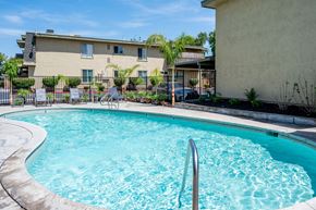 Manteca apartment for rent - a swimming pool with a building in the background