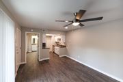 Tyler apartment for rent - View from living area into kitchen and bedroom. Ceiling fan in living area, whit cabinets and stainless appliances in kitchen
