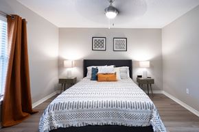 Tyler apartment for rent - A bedroom with a large bed and two lamps.
