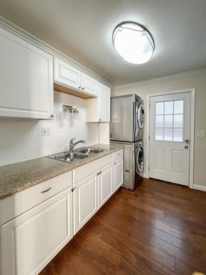 Hermosa Beach apartment for rent - kitchen with granite counters, wood floors, and stacked washer dryer