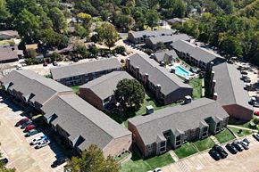 Huntsville apartment for rent - an aerial view of a building with cars parked in a parking lot