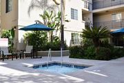 Sherman Oaks apartment for rent - View of spa with seating and umbrella and tropical landscaping