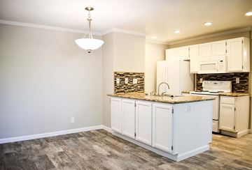 Simi Valley apartment for rent - a kitchen with white cabinets and a counter top