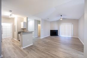 Bossier City apartment for rent - an empty living room and kitchen with a wood floor