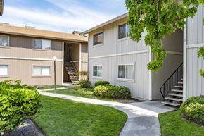 Manteca apartment for rent - the outlook of a building with stairs and a sidewalk