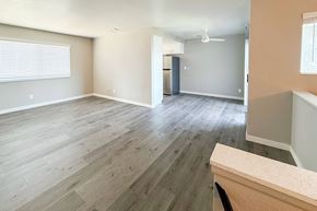 Lompoc apartment for rent - A room with wooden flooring and a ceiling fan.