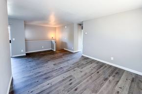 Lompoc apartment for rent - A room with wooden flooring and white walls.