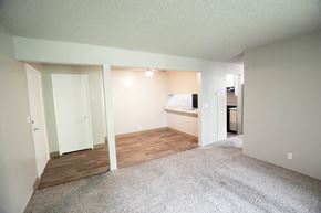 Chico apartment for rent - an empty living room with wood flooring and a kitchen