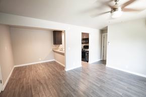 Chico apartment for rent - an empty living room with wood flooring and a kitchen